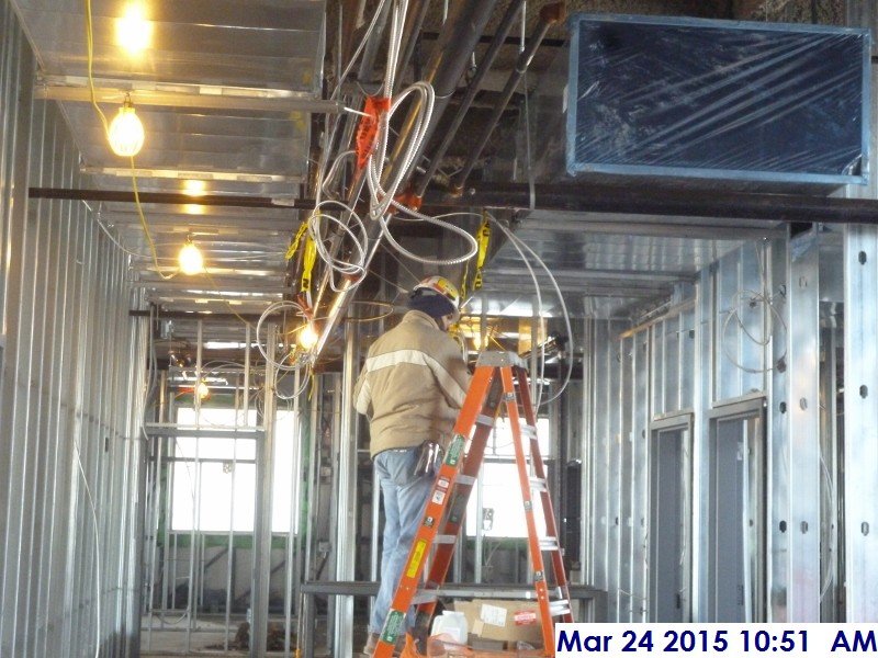 Installing electrical wire above the ceiling at the 4th floor Facing West